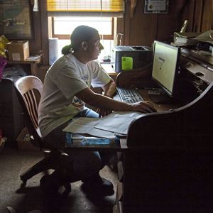 Bethany Coursen of Spring Mills uses the internet in the office of her family farm, Valley Wide dairy farm, to look through feed, milk production and ovulation data collected by their Lely Astronaut A4, a robotic milking machine made by the Dutch company Lely, Wednesday, June 12, 2019, at the Valley Wide Farm in Spring Mills. 