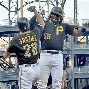 Pittsburgh Pirates' Kimera Bartee and Josh Bell watch as the team