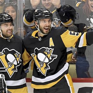 In this file photo, Penguins center Dominik Simon congratulates defenseman Kris Letang on his goal against the Stars in the third period Friday, Oct. 18, 2019, at PPG Paints Arena. Letang became the latest Penguins player to leave a game with an injury on Monday in Boston. 