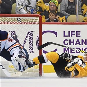 Bryan Rust collides with Oilers goaltender Mike Smith Saturday, Nov. 2, 2019, at PPG Paints Arena.
