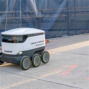 A Starship food delivery robot drives along Fifth Avenue in Oakland on Monday, Jan. 13, 2020. 