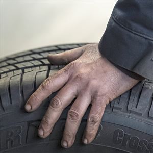 Tire tech Steve Pearce works on a client's truck tires on Wednesday, March 25, 2020, at Ronnie's Tire Service in Carrick.