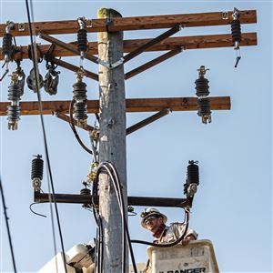 Mike Joyce, a journeyman underground splicer with Duquesne Light, works on a utility poll on Friday, May 15, 2020, in Oakland.