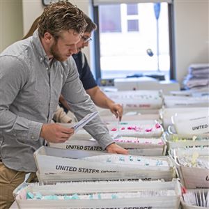 Tim Vernick, an election worker, sorts through mail-in ballots in the Butler County Election Bureau in Butler, Pa., in this June 1, 2020 file photo. 