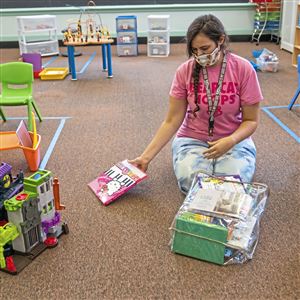 Sarah Harwick, a pre-K teacher, sets up her classroom to accommodate six students at Sister Thea Bowman Catholic Academy in Wilkinsburg on Monday.