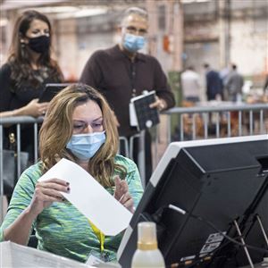 The Allegheny County Return Board processes the remaining overseas and military ballots while election observers watch on Friday, November 6, 2020, in the warehouse on the North Side. 