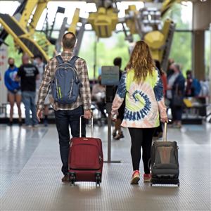 A couple heads to the ticket counter at the Pittsburgh International Airport Friday, May 28, 2021 in Coroapolis. The duo were in town for the East Coast Volleyball Championships being held at the David L. Lawrence Convention Center.