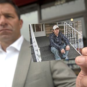 State Rep. Jim Struzzi holds a photograph of his younger brother, Mike, that he carries in his wallet in front of his Indiana office Thursday, July 29, 2021 in Indiana County. His brother died of a drug overdose due to a combination of substances. Jim Struzzi has been sponsoring legislation since last year that would allow fentanyl strips to be distributed throughout the state. The strips would alert people to the presence of the drug.
