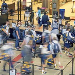 Passengers make their way through a security line at Pittsburgh International Airport on Monday, Nov. 8, 2021. 