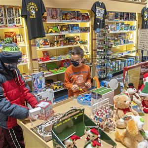 Brothers Eli, 13, left, and William Vandermallie, 9, of Ambridge, look at a Jack in the Box and other toys at S.W. Randall Toys during Small Business Saturday on Nov. 27, 2021, Downtown. S.W. Randall Toys was one of the businesses participating in the Downtown Pittsburgh Partnership’s “Downtown Elf Hunt,” where elves were hidden with QR codes for customers to find and scan for a chance to win prizes. (Emily Matthews/Post-Gazette) 