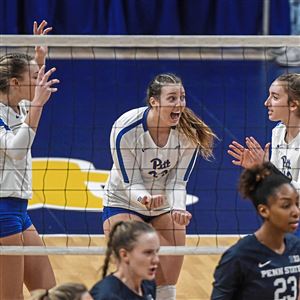 Pitt players Rachel Fairbanks (10), Kayla Lund (23) and Emmy Klika celebrate a point against Penn State during the second round of the 2021 NCAA tournament on Saturday. 