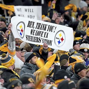 Pittsburgh Steelers quarterback Ben Roethlisberger (7) walks off the field  holding the jersey of linebacker Ryan Shazier after beating the Baltimore  Ravens 39-38 to clinch the AFC North Championship in an NFL