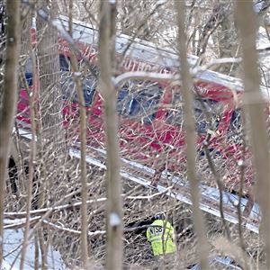 NTSB officials inspect around the Port Authority bus on the collapsed Fern Hollow Bridge on Saturday, Jan. 29, 2022, in Frick Park.