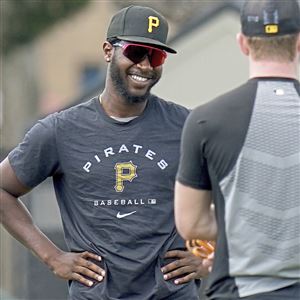Pirates pitcher Tahnaj Thomas talks with teammates during minor league spring training in February.