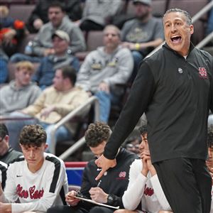 New Castle coach Ralph Blundo shouts to his team during its game against Imhotep Charter in the PIAA Class 5A boys basketball championship in Hershey. New Castle lost, 54-39. 