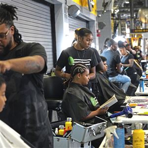 Children get their haircut and styled by stylists from Dreamz Hair Salon during Pittsburgh Public School’s Back-to-School event on Monday, Aug. 22, 2022, at Heinz Field on the North Shore. 