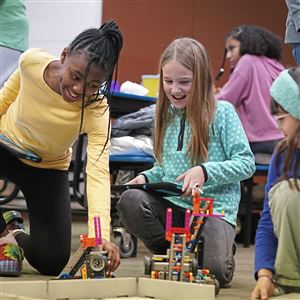 Woodland Hills fifth graders Chrissy Bliss, 10, left, Katelyn Pittler, 10, and fourth grader Emma Gensure, 9, test their robot’s skill at Woodland Hills’ after school mother-daughter Robotics/STEM club at the new Rankin Community Center in Rankin Wednesday, Jan. 17, 2024.