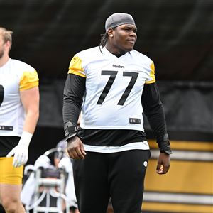 Steelers tackle Broderick Jones walks on the field between drills at OTAs practice Thursday at UPMC Rooney Sports Complex on the South Side.