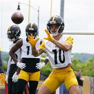 Steelers rookie wide receiver Roman Wilson looks in a pass during a drill at OTA practice at UPMC Rooney Sports Complex on the South Side Thursday, May 23, 2024.
