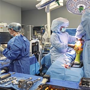 UPMC surgeon Dr. Ken Urish, right, and his team perform a robotics assisted knee replacement at UPMC Magee-Womens Hospital in Oakland Friday, Oct. 25, 2024. 