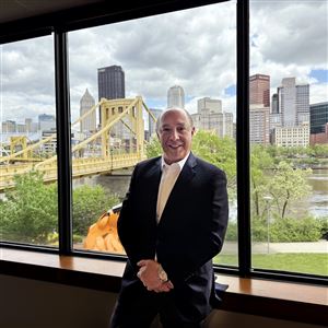 Matthews International Corp. CEO Joseph Bartolacci, shown here with the City of Pittsburgh in background at the offices on the North Shore, says the company's stock will rebound from a 52-week low.