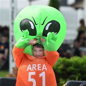 Gabe Walowen fixes his alien head to get ready for the Costume contest during the Mars New Years Festival in Mars on Saturday June 7, 2025. 