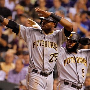 Gregory Polanco and Josh Harrison celebrate after scoring on a double by Starling Marte against the Colorado Rockies last week at Coors Field in Denver, Colorado.