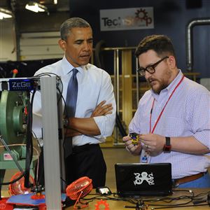 President Obama listens as Andy Leer gives demonstration on a 3D printer during a visit to TechShop Pittsburgh in Bakery Square in 2014.