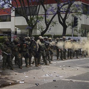 Border Patrol personnel deploy tear gas Saturday during a demonstration over the dozens detained in an operation by federal immigration authorities a day earlier in the Paramount section of Los Angeles.