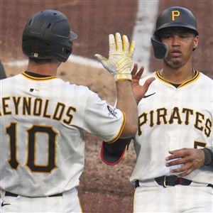Pittsburgh Pirates' Endy Rodriguez, right, is greeted by Bryan Reynolds after scoring on a sacrifice fly by Andrew McCutchen off Houston Astros pitcher Ryan Gusto in Pittsburgh, Wednesday, June 4, 2025.
