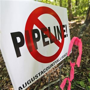 In this Tuesday June 6, 2017 file photo, a No Pipeline sign is posted next to a property line marker only a few feet from the center line of the route of the proposed Atlantic Coast Pipeline in Bolar, Va.
