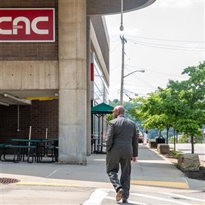 CCAC President Quintin Bullock walks down the sidewalk of the North Side campus on Monday, May 22, 2023. 