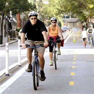 Bicyclists on the Penn Avenue bike lanes Downtown.