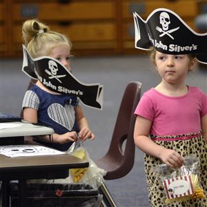 In this Sept. 19 file photo, wearing pirate hats donated by the local Long John Silver's restaurant and carrying bags of 