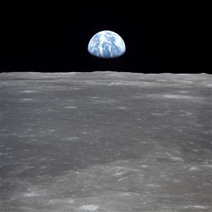 Image taken from Apollo 11 spacecraft showing the Earth rising over the horizon on the lunar surface.   