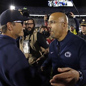 Penn State coach James Franklin, right, and Michigan coach Jim Harbaugh, left, meet after an NCAA college football game in State College, Pa., Saturday, Oct. 19, 2019. Penn State won 28-21.
