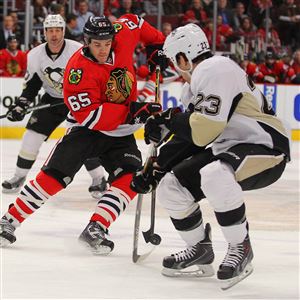 Chicago Blackhawks center Andrew Shaw (65) skates with the puck as  Penguins right winerg Steve Downie (23) defends in the first period at United Center in Chicago.