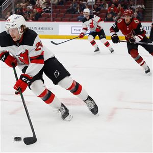 Ty Smith #24 of the New Jersey Devils skates with the puck during the first period of the NHL game against the Arizona Coyotes at Gila River Arena on April 12, 2022 in Glendale, Arizona.