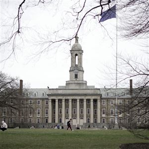 Students gather outside Old Main on the Penn State University main campus in State College, Pa., Friday, March 24, 2023.
