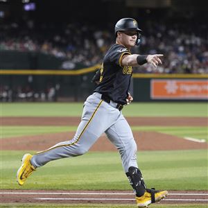 Pittsburgh Pirates' Henry Davis, right, celebrates his two-run home run against Arizona Diamondbacks starting pitcher Corbin Burnes, left, during the sixth inning of a baseball game Tuesday, May 27, 2025, in Phoenix. 