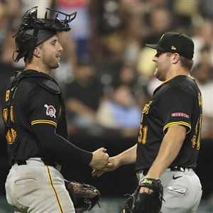 Pittsburgh Pirates' Joey Bart, left, celebrates with David Bednar, right, after their win over the Chicago White Sox, Friday, July 12, 2024, in Chicago.