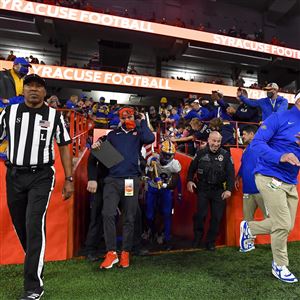 Pittsburgh head coach Pat Narduzzi, right, leads his team onto the field before an NCAA college football game against Syracuse in Syracuse, N.Y., Saturday, Nov. 27, 2021.