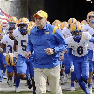 Pittsburgh head coach Pat Narduzzi leads his team onto the field for a 2021 game at Virginia Tech. 