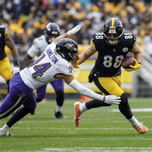 Washington Commanders linebacker Cole Holcomb (55) tackles Green Bay Packers  running back AJ Dillon (28) during