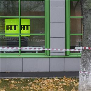 In this file photo, the Russian state-owned television station RT logo is seen at the window of the company's office in Moscow on Oct. 27, 2017.