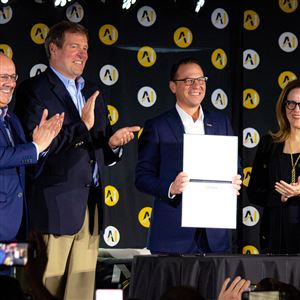 Pennsylvania Gov. Josh Shapiro displays a signed agreement with Carnegie Mellon president Farnam Jahanian, Vice President of Nvidia Federal Anthony Robbins, and University of Pittsburgh Chancellor Joan Gabel at Monday’s AI Horizons summit in Bakery Square. 