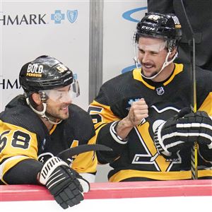 Pittsburgh Penguins' Sidney Crosby (87) and Evgeni Malkin (71) sit on the  bench during the first period of an NHL hockey game against the Vancouver  Canucks in Pittsburgh, Tuesday, Jan. 10, 2023.