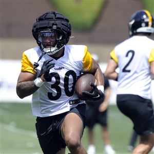 Check out Steelers LB T.J. Watt as he signs a baby at training camp