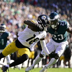 Washington Commanders linebacker Cole Holcomb (55) tackles Green Bay Packers  running back AJ Dillon (28) during