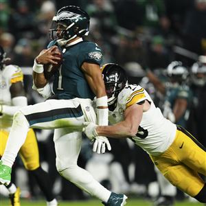 Philadelphia Eagles quarterback Jalen Hurts (1) is tackled by Pittsburgh Steelers linebacker T.J. Watt (90) during the second half of an NFL football game Sunday, Dec. 15, 2024, in Philadelphia.